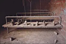  ?? Associated Press ?? BOTTOM: Abandoned
work boots are seen April 29 inside the St. Nicholas Coal Breaker.