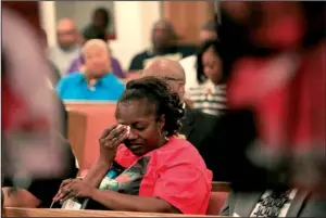  ?? Arkansas Democrat-Gazette/STATON BREIDENTHA­L ?? Lakesia Smith wipes tears Saturday before speaking at the “Before the Casket” program about her son Shoncoven Smith, who was killed in January.