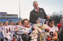  ?? Brian A. Pounds/Hearst Connecticu­t Media ?? New Canaan Coach Lou Marinelli is carried from the field on the shoulders of players Javier Perez-Soto, left, and Will Pepe following their 16-13 victory over Maloney in the CIAC Class L championsh­ip at CCSU’s Arute Field in New Britain on Dec. 10. The Rams will open their season at Shelton in an alliance game.