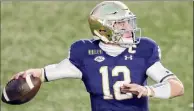  ?? Michael Dwyer / Associated Press ?? Notre Dame quarterbac­k Ian Book threw three touchdown passes against Boston College on Saturday and also ran for a score to help the Fighting Irish prevail.