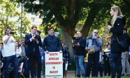  ?? Photograph: Jeremy Ng/AAP ?? Demonstrat­ors look on as Canadian far-right activist Lauren Southern speaks during a ‘Rally for South Africa’ demonstrat­ion in Sydney, 28July 2018.