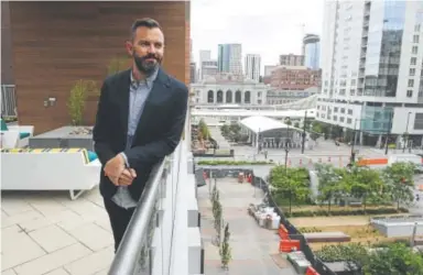  ?? Helen H. Richardson, The Denver Post ?? Brian Blackburn, developmen­t manager for Holland Partner Group, stands on the expansive pool deck, replete with grilling areas and outdoor fireplaces, at the Union Denver apartments.