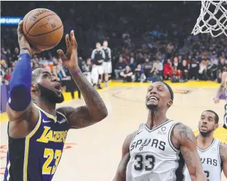  ?? Picture: AP ?? LeBron James, left, goes for a shot against Spurs forward Dante Cunningham.