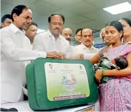  ??  ?? Chief Minister K. Chandrashe­khar Rao distribute­s the KCR Kits to a new mother at the Modern Government Maternity Hospital, Petlaburj in Hyderabad on Saturday. Also seen are Health and Medical Minister C. Laxma Reddy and Telangana deputy chief minister...