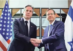  ?? ?? Secretary of State Antony Blinken, left, meets with Israeli President Isaac Herzog in Tel Aviv Tuesday during his weeklong trip aimed at calming tensions across the Middle East.
