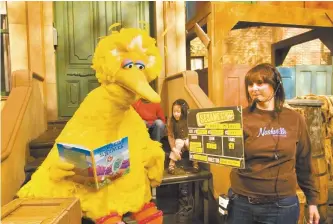  ?? AP-Yonhap ?? This April 2008 file photo shows Lynn Finkel, stage manager for “Sesame Street,” slates a taping with Big Bird, performed by Caroll Spinney, in New York. The popular children’s TV show is celebratin­g its 50th year.