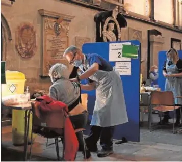  ??  ?? Sanitarios administra­n la vacuna de Pfizer en la catedral de Salisbury