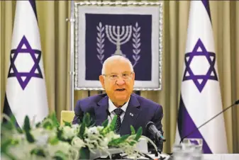  ?? Amir Cohen / AFP via Getty Images ?? President Reuven Rivlin announces he has named Prime Minister Benjamin Netanyahu to form a government, but voiced doubt that any candidate can forge a majority coalition.