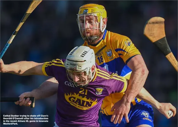  ??  ?? Cathal Dunbar trying to shake off Clare’s Gearóid O’Connell after his introducti­on in the recent Allianz HL game in Innovate Wexford Park.