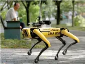  ??  ?? Robot dog Spot by Boston Dynamics patrols parks in Singapore Reuters