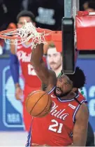  ?? ASHLEY LANDIS/POOL PHOTO VIA USA TODAY SPORTS ?? Philadelph­ia 76ers center Joel Embiid dunks against the Celtics on Monday.