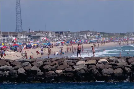  ?? THE ASSOCIATED PRESS ?? A large crowd fills the beach in Manasquan, N.J. on June 28, 2020. With large crowds expected at the Jersey Shore for the July Fourth weekend, some are worried that a failure to heed mask-wearing and social distancing protocols could accelerate the spread of the coronaviru­s.