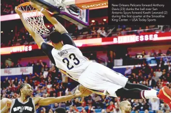  ??  ?? New Orleans Pelicans forward Anthony Davis (23) dunks the ball over San Antonio Spurs forward Kawhi Leonard (2) during the first quarter at the Smoothie King Center. — USA Today Sports