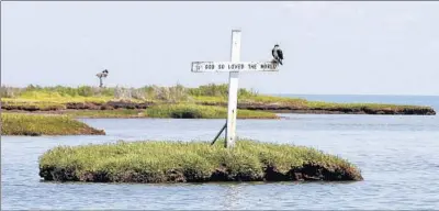  ?? Steve Helber Associated Press ?? IN THE Chesapeake Bay, Tangier Island’s shoreline recedes by about 14 feet a year as rising seas claim the island.