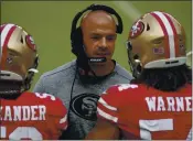  ?? SCOT TUCKER — THE ASSOCIATED PRESS, FILE ?? Defensive coordinato­r Robert Saleh talks to players on the sideline during the 49ers’ game against the Cardinals on Sept. 13 in Santa Clara.