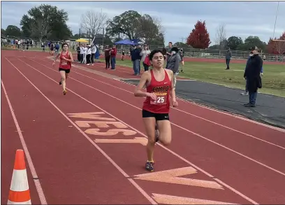  ?? JUSTIN COUCHOT — ENTERPRISE-RECORD ?? Chico High senior cross country runners Iresh Molina, right, and Della Molina prepare to cross the finish line at the CIF Northern Section Finals on Wednesday at West Valley High.