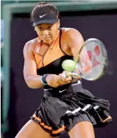  ?? — AFP ?? Japan’s Naomi Osaka hits a return against Bulgaria’s Viktoriya Tomova at the Pan Pacific Open.