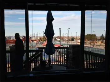  ?? RJ SANGOSTI — THE DENVER POST ?? Bill Kemrper stands on his back deck overlookin­g 24pickleba­ll courts located at the Simms Street Recreation Center in Arvada on Thursday. Kemrper said that he is now used to the noise that often comes from living close to the courts.