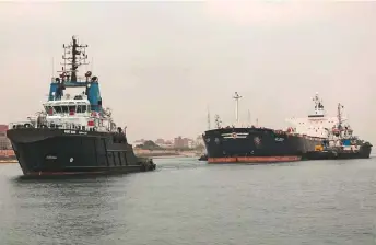  ?? AFP ?? A tugboat pulls the Marshall Islands-flagged bulk carrier M/V Glory in the Suez Canal near Al Qantarah between Port Said and Ismailia yesterday.