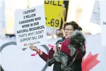  ??  ?? This woman joined protesters to send a message to Finance Minister Bill Morneau about the urgent need to build the Trans Mountain pipeline.