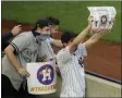  ?? FRANK FRANKLIN II - THE ASSOCIATED PRESS ?? New York Yankees fans hold signs before the start of a baseball game between the New York Yankees and the Houston Astros Tuesday, May 4, 2021, in New York.