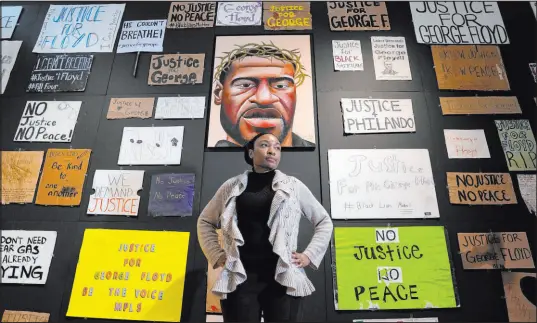  ?? Ross D. Franklin The Associated Press ?? Jeanelle Austin, director of the George Floyd Global Memorial, pauses Friday during the installati­on of “Twin Flames: The George Floyd Uprising from Minneapoli­s to Phoenix,” at the Arizona State University Art Museum in Tempe, Ariz.