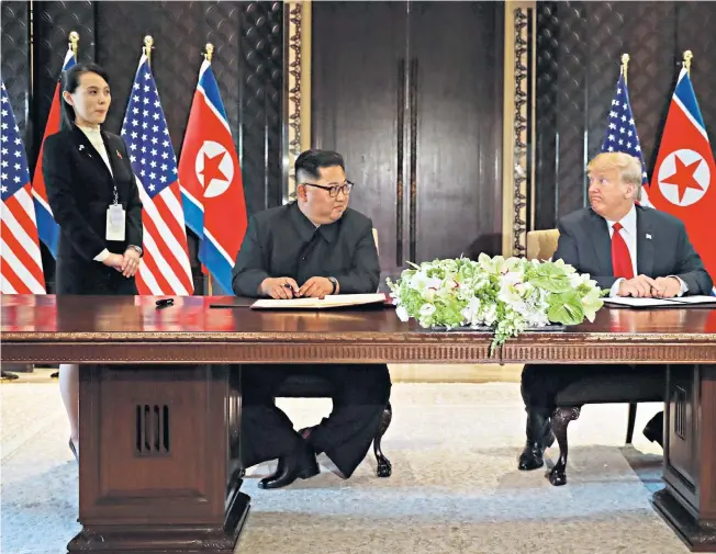  ??  ?? Clockwise from top: Kim and Mr Trump at the signing with Kim Jo-yong and Mike Pompeo; an aide prepares a pen for Kim, which he did not use; the signed papers; Mr Trump shows Kim his $1.6 million limousine