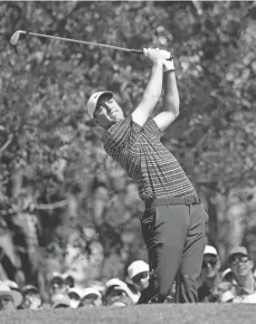  ?? ?? Scottie Scheffler tees off on the fourth hole in the final round of the Masters on Sunday at Augusta National Golf Club. ANDREW DAVIS TUCKER/AUGUSTA CHRONICLE