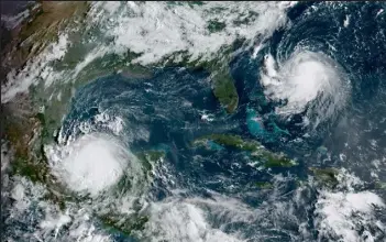  ?? Handout / Getty Images ?? his National Oceanic and Atmospheri­c Administra­tion satellite handout image shows Hurricane Grace and Tropical Storm Henri on August 20, 2021.