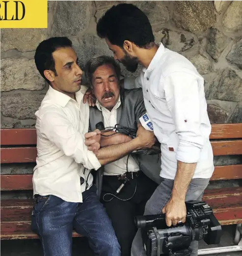  ?? RAHMAT GUL / THE ASSOCIATED PRESS ?? A man cries at a hospital after losing his son, a journalist, in a suicide bombing in Kabul, Afghanista­n, on Monday.