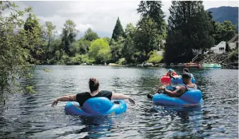  ?? CHAD HIPOLITO, VIA VANCOUVER SUN ?? Tubers float on the Cowichan River in July 2018.