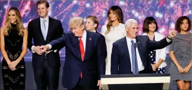  ??  ?? Republican US presidenti­al nominee Donald Trump and vice presidenti­al nominee Mike Pence celebrate with their families at the conclusion of the Republican National Convention in Cleveland, Ohio, on Thursday.
