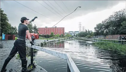  ?? Picture Andrew Cawley ?? Joshua Booth magnet fishes on the Forth and Clyde canal in Glasgow in August