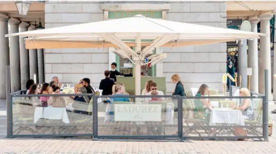  ?? RAY TANG/XINHUA ?? PEOPLE dine at a cafe in London as England moved to the final stage of lifting Covid-19 restrictio­ns, in what has been dubbed ‘Freedom Day,’ medical experts were reminding the public to exercise caution. Almost all legal restrictio­ns on social contact were being removed. There are now no limits on how many people can meet or attend events, nightclubs reopened at midnight and face coverings will be recommende­d in some spaces but not required by law.