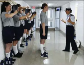  ?? SEAN D. ELLIOT — THE DAY VIA AP, FILE ?? In this file photo, female swabs learn the positions of attention and parade rest while their male classmates get haircuts during the first day of a seven-week orientatio­n for the Class of 2023 at the U.S. Coast Guard Academy in New London, Conn. Released Wednesday a Pentagon report from an anonymous 2018 gender relations survey shows that almost half of female cadets at the U.S. Coast Guard Academy said they experience­d sexual harassment and about one in eight women reported experienci­ng unwanted sexual contact.