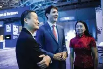  ?? CHRISTOPHE­R KATSAROV, THE CANADIAN PRESS ?? Prime Minister Justin Trudeau tours the market place with Alibaba Group founder Jack Ma at the Gateway Conference in Toronto,