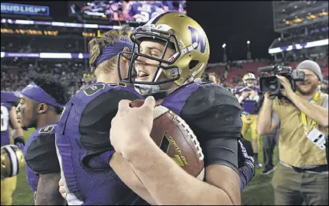  ?? ROBERT REINERS / GETTY IMAGES ?? Quarterbac­k Jake Browning (right) made an unexpected jump during his sophomore season — and so did Washington, which won the Pac-12 championsh­ip and qualified for the playoff semifinals.