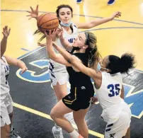  ?? ?? Sandburg’s Lauren Coghlan gets fouled on a layup by Lincoln-Way East’s Morgan Montaque.