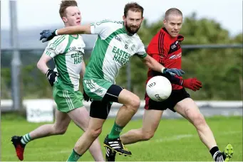  ??  ?? Kevin Gallagher, Eastern Harps and Jonathan Davey of St Mary’s in a battle for possession.