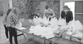  ?? Olivia Morley, File ?? In this November 2020 photo, student volunteers put together to-go bags and boxes at the Rome Noon Optimist Club’s 60th annual Pancake Breakfast.