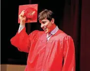  ?? THE OKLAHOMAN]
[PHOTO BY SARAH PHIPPS, ?? Kevin Diaz Ramos waves to the crowd May 19 during English Language Learner graduation ceremonies at U.S. Grant High School in Oklahoma City.