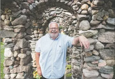  ?? (The Albert Lea Tribune/Colleen Harrison) ?? Eugene Stenzel stands next to one of his stone works outside his home north of Wells, Minn. The 80-year-old Stenzel has been building creations out of stone since he was 10 years old, when his first effort was a shrine or grotto for the Virgin Mary.