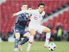  ??  ?? Scotland’s Andy Robertson takes on Portugal’s Helder Costa.