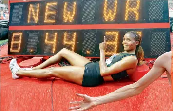  ??  ?? Beatrice Chepkoech of Kenya poses below the indicating board after setting a new women’s 3000m steeplecha­se World Record during the IAAF Diamond League Athletics meet at the Louis II Stadium in Monaco on Friday. — AP