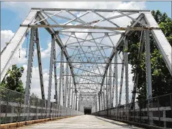  ?? MARY HUBER / BASTROP ADVERTISER ?? Bastrop’s iconic Old Iron Bridge will undergo a makeover beginning this month. The landmark was built in 1923.