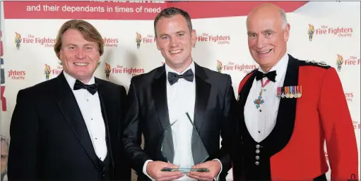  ??  ?? n PRESENTATI­ON: Gareth Salmon receives his award from David Domoney, from ITV’s Love your Garden, and Chief Fire and Rescue Advisor Peter Holland