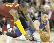  ?? AP ARCHIVES ?? LeBron James and Stephen Curry battle for a loose ball on Christmas Day. The Cavaliers have had some success getting physical with Curry.