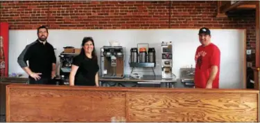  ?? KRISTI GARABRANDT — THE NEWS-HERALD ?? From left to right, McPat Coyne, Meghan Klicman and Seamus Coyne stand in their newly renovated coffee shop. Fiona’s will take the place of Arabica Coffee in downtown Willoughby.