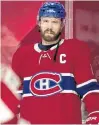  ?? POSTMEDIA NEWS ?? Canadiens captain Shea Weber looks on as goalie Carey Price makes a save during pregame warmup before a game at the Bell Centre in Montreal earlier this season.