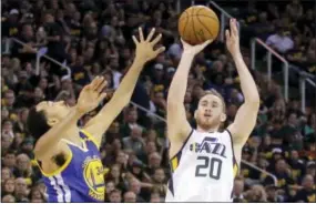  ?? RICK BOWMER — THE ASSOCIATED PRESS ?? In this May 6 file photo, Utah Jazz forward Gordon Hayward (20) shoots as Golden State Warriors guard Shaun Livingston (34) defends in the second half during Game 3 of the NBA basketball second-round playoff series in Salt Lake City.